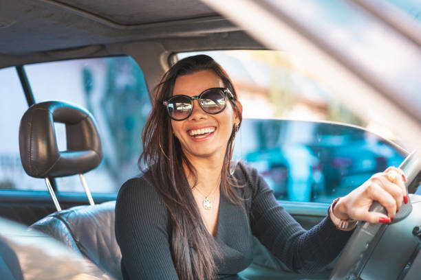 happy brunette woman driving a car - car equipment smiling working imagens e fotografias de stock