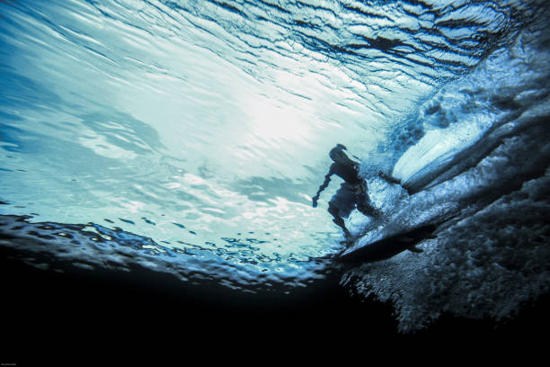 istock Underwater view of surfer riding wave 1163629553