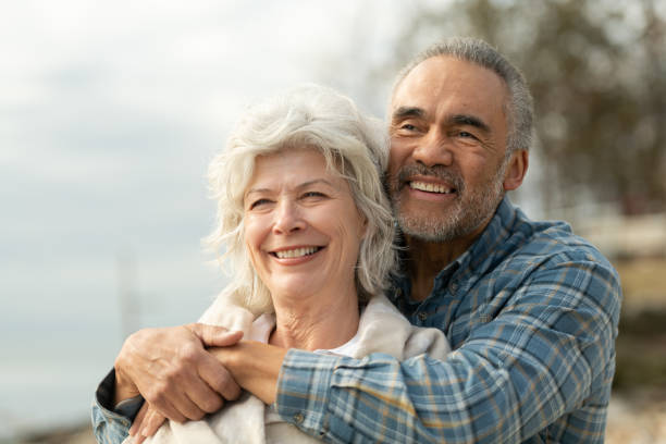 istock Laughing senior couple on a beach 1163630140