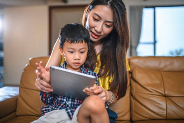 istock Taiwanese Mother Teaching Young Son How to Use Digital Tablet 1163630200
