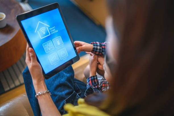 istock Taiwanese Mother Showing Son How to Use Smart Home System App 1163630203