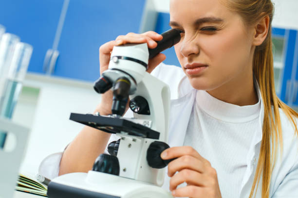 istock Young chemistry teacher in school laboratory workplace magnification 1163630902