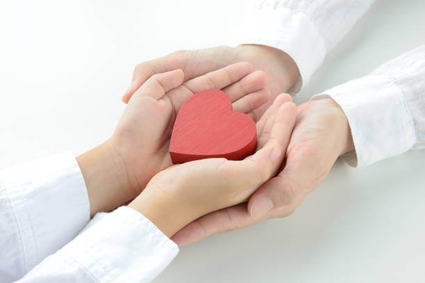 istock Heart object held by child and mom's hands 1163632880