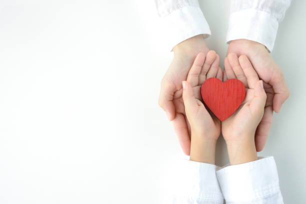 istock Heart object held by child and mom's hands 1163632922