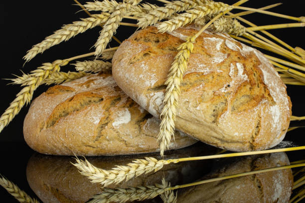 istock Rye wheat bread isolated on black glass 1163632934