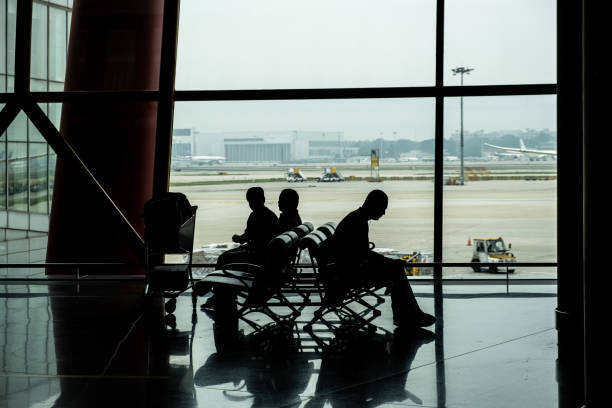 istock People silhouettes waiting in Airport terminal 1163633741