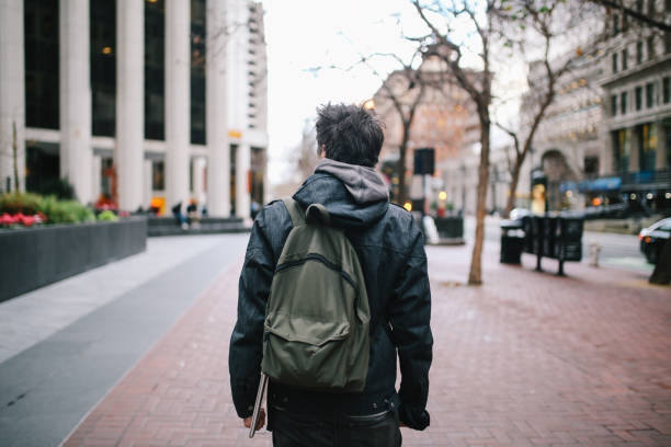 istock Young man walking in San Francisco, California 1163635184