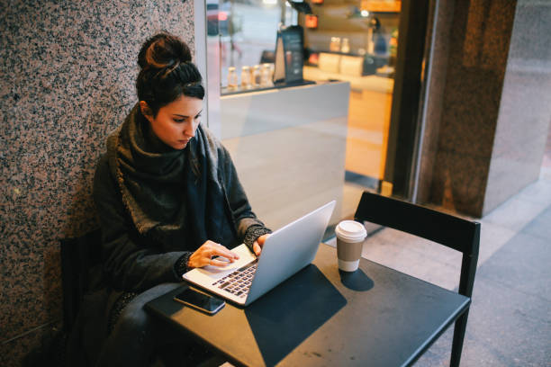 istock Young woman finishing work outdoors on the go 1163635294