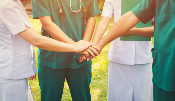 istock ogether collaborate of hands docter and nurse teamwork 1163635340