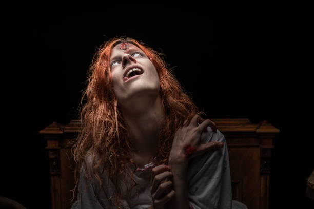istock Scary woman possessed by devil in the bed. Exorcism of priest. 1163636800