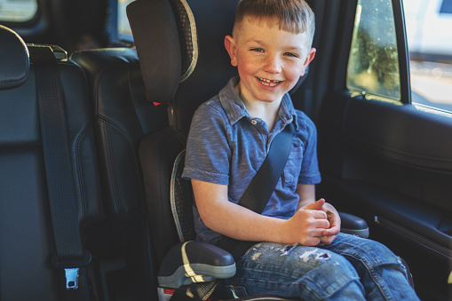 Travel with Child or Children strapped in safety belts in automobile looking at camera series Western Colorado (Shot with Canon 5DS 50.6mp photos professionally retouched - Lightroom / Photoshop - original size 5792 x 8688)