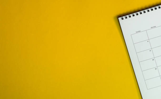 istock Yellow office desk top view with table calendar 1163640226