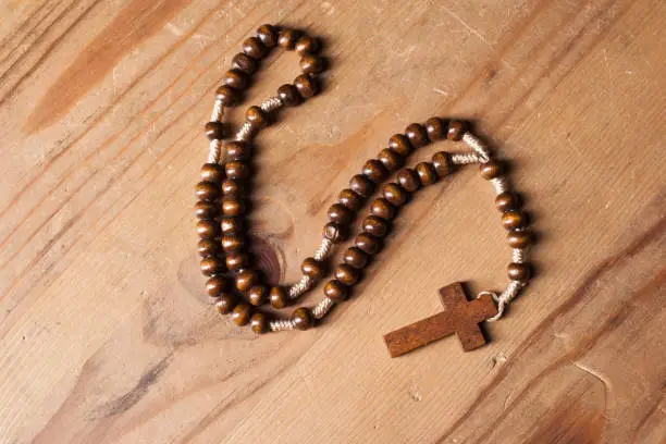 Photo of Christian rosary on wooden table