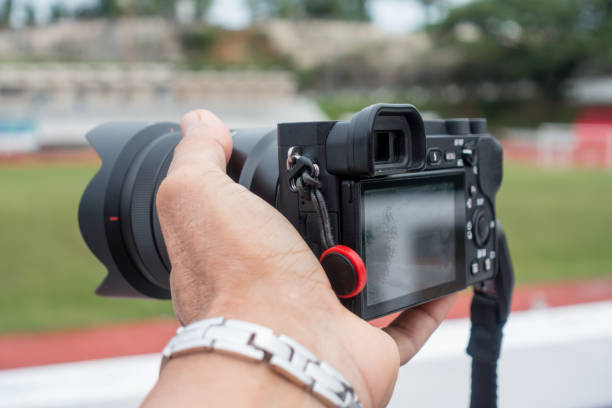 istock Male hand holding a digital camera. 1163644033