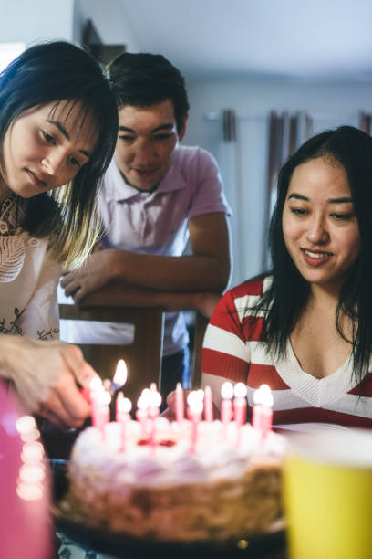 istock Lighting the birthday cake candles 1163645608