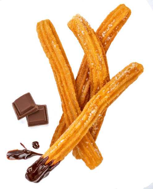 istock Churros isolated on white background with chocolate chunk. Traditional Mexican  cusine. Churro close up 1163646362