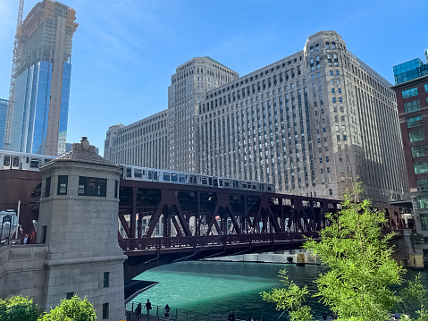 Chicago el train crossing the Chicago River at Wells St during colorful summer afternoon in the Loop
