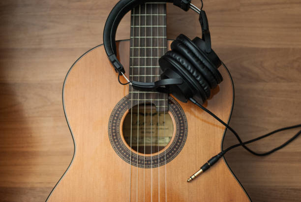 istock Acoustic guitar resting against a wooden background 1163654046