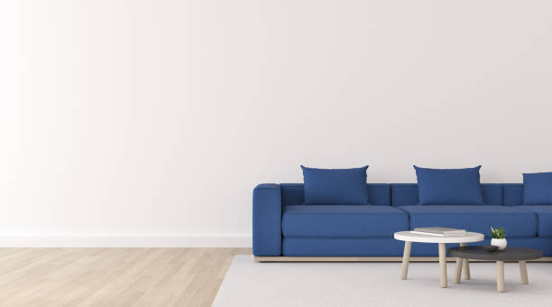 istock View of white living room in minimal style with deep blue fabric sofa and small side table on wood laminate floor.Perspective of Scandinavian interior with hanging lamp design. 3d rendering. 1163654228