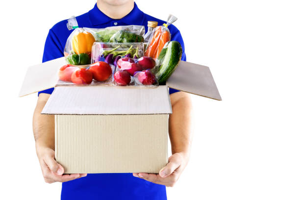 Food delivery service for order online grocery shopping concept. Delivery man in blue uniform hand holding paper box package. Express delivery service fast food for lifestyle in city concept. Food delivery service for order online grocery shopping concept. Delivery man in blue uniform hand holding paper box package. Express delivery service fast food for lifestyle in city concept. 9. Grocery Shopper/Delivery Driver stock pictures, royalty-free photos & images