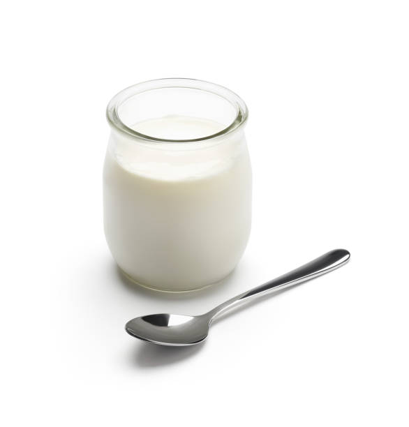 Glass jar yogurt with spoon isolated on white background - clipping path included Glass jar yogurt with spoon isolated on white background - clipping path included greek yogurt photos stock pictures, royalty-free photos & images