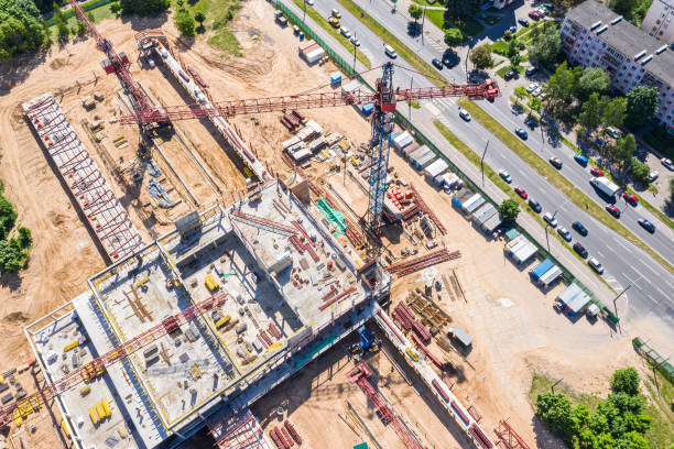 istock industrial tower crane standing high at city construction site. aerial view 1163655108