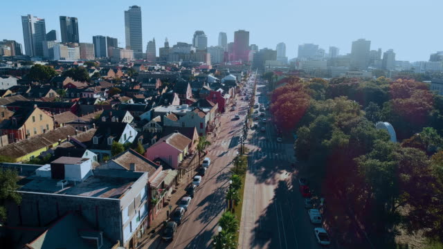 Busy North Rampart Street in New Orleans, Louisiana, at evening, with the remote view along the street to the downtown financial district. Aerial drone video with the cinematic slow forward camera motion.