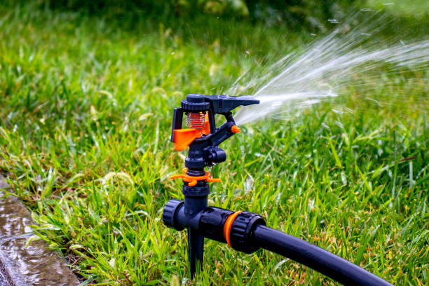 istock Sprinkler. Automatic irrigation system on the background of green grass. Lawn watering system. Freshness concept 1163659752