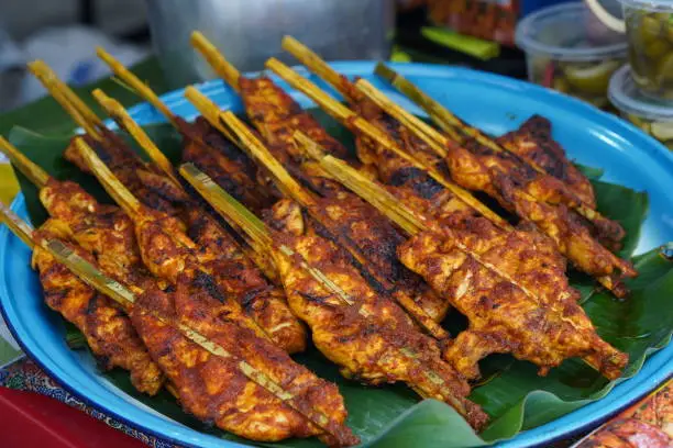 Photo of Malaysian traditional dishes, popular grilled spiced chicken Ayam Percik selling in Bazaar during the holy month of Ramadan.