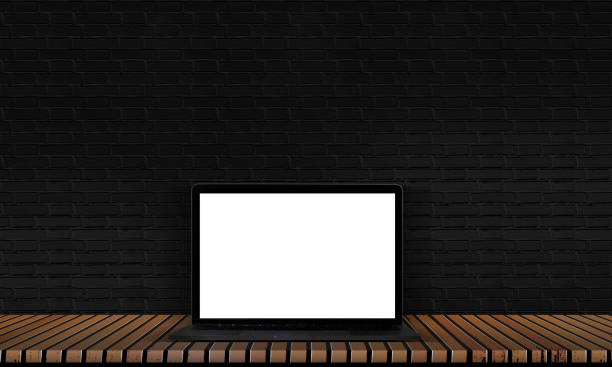 istock Laptop on a wooden floor with black brick floors and solid wood for interior decoration. 1163663982