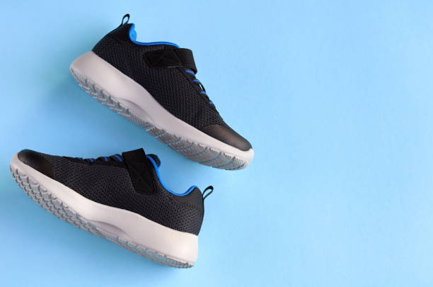 istock Sneakers on blue background composition, shoes for run. 1163665088