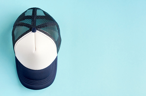 Baseball cap on blue background composition. Flat lay and top view photo