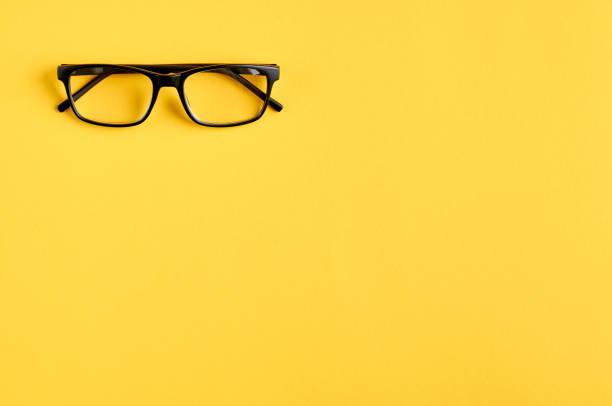 istock Black glasses on yellow background composition, eyeglasses. 1163665231