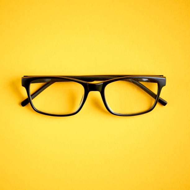 istock Black glasses on yellow background composition, eyeglasses. 1163665232