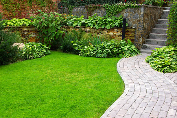 Garden Garden stone path with grass growing up between the stones ornamental garden stock pictures, royalty-free photos & images