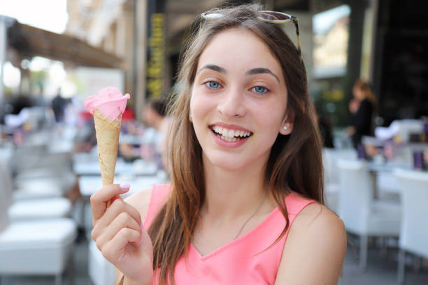 istock Beautiful girl eating ice cream 1163666664