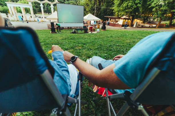istock eating snacks drinking beer movie in open air cinema 1163666741