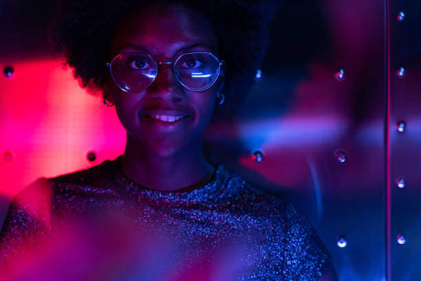 istock Woman at disco club with colorful light effects 1163667601