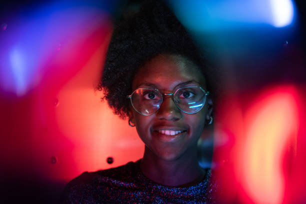 istock Woman at disco club with colorful light effects 1163667602