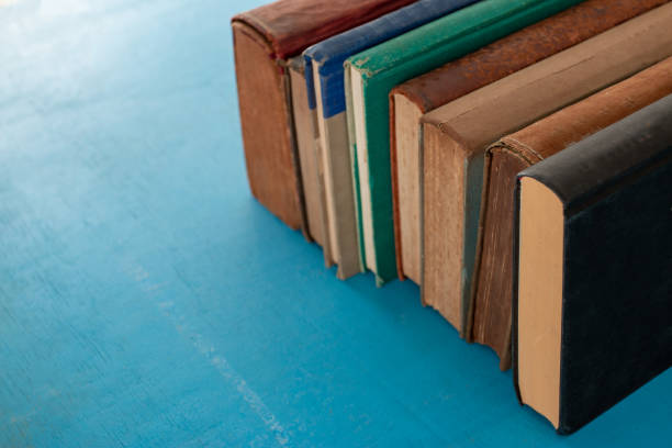 istock Old books on a blue-green wooden. 1163669963