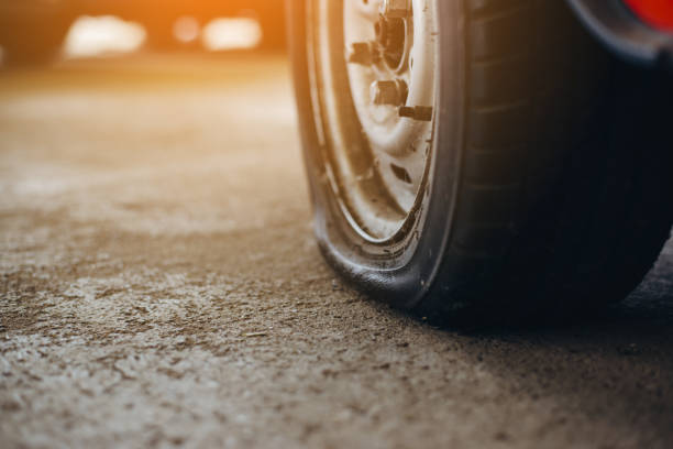 Selective focus flat tire of old car park on the street waiting for repair,copy space, (vintage tone) Selective focus flat tire of old car park on the street waiting for repair,copy space, (vintage tone) flat tire stock pictures, royalty-free photos & images