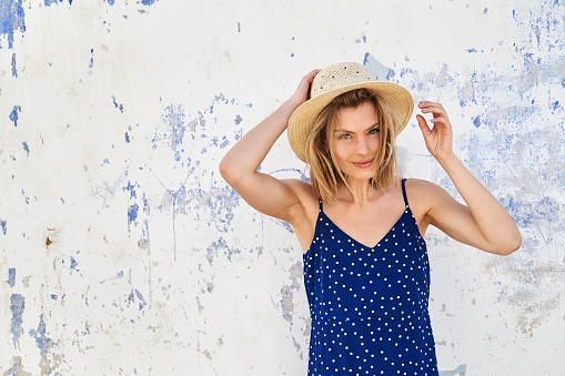 Beautiful girl in straw hat and blue dress, portrait
