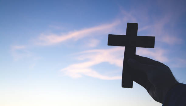 istock Male hand holding christian cross. 1163671764