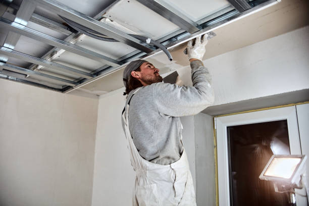 istock Construction worker plastering gypsum walls inside the house. 1163673077