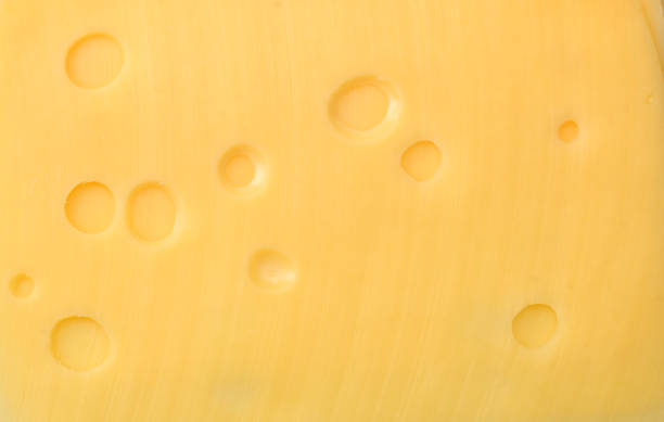 istock cheese slices background. cheese slices texture. top view 1163674229