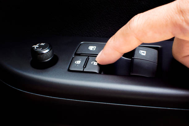 istock Finger press the car door lock button. 1163674972