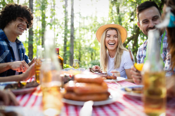 istock Group of happy friends eating and drinking beers at barbecue dinner 1163675708