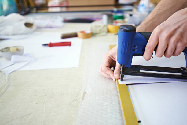 istock Closeup of man fitting picture in frame 1163676047