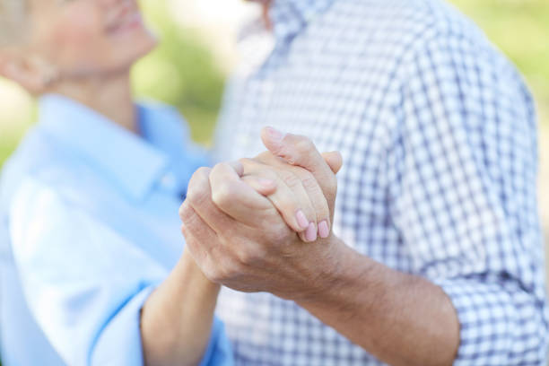 istock Senior Couple Dancing in Park 1163677935