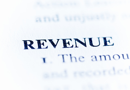 In a business dictionary, the definition for Revenue is shown.